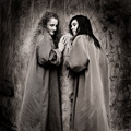 Two Woman and Distressed Wall, Paisley, Scotland.